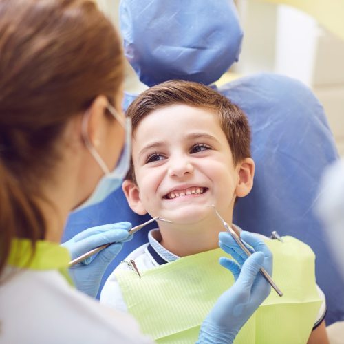 A child with a dentist in a dental office. A child with a dentist in a dental office. Dental treatment in a children's clinic.